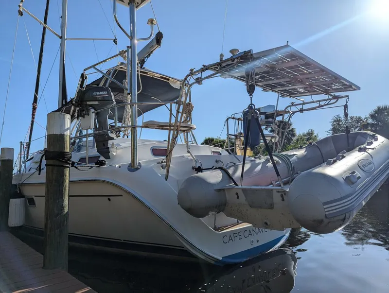 Slide: The Image of Hunter 45 Center Cockpit 2007 sailboat docked with dinghy and solar panels. - 22