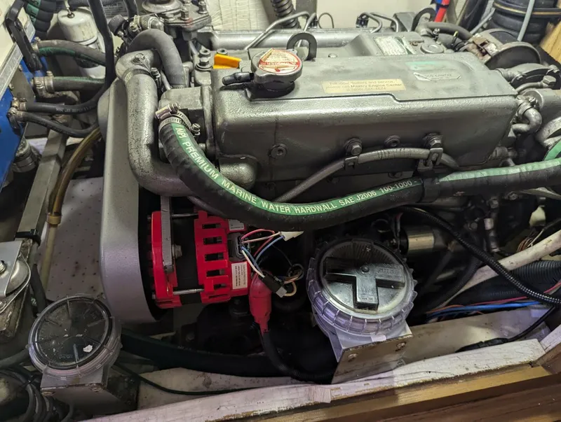 Slide: The Image of Engine compartment of a 2007 Hunter 45 Center Cockpit sailboat, showing detailed components and hoses. - 30