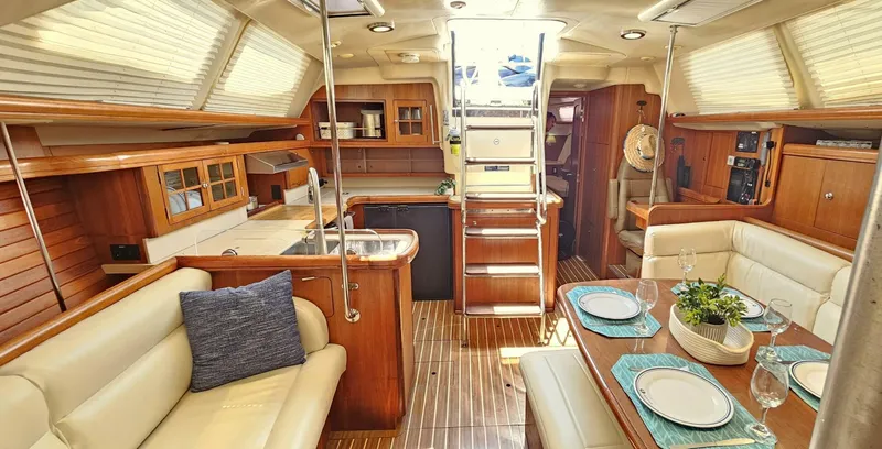 Slide: The Image of Luxurious 2007 Hunter 45 Center Cockpit interior with elegant dining area and modern kitchen. - 5