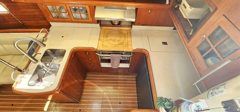 Slide: The Image of Interior of 2007 Hunter 45 Center Cockpit yacht, featuring a well-equipped kitchen area. - 7