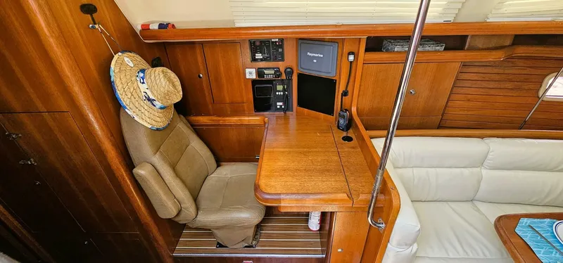 Slide: The Image of Interior of 2007 Hunter 45 Center Cockpit yacht with navigation station and seating area. - 8