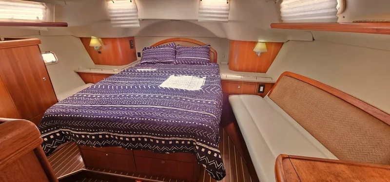 Slide: The Image of Luxurious 2007 Hunter 45 Center Cockpit bedroom with cozy bed and elegant wood finishes. - 9
