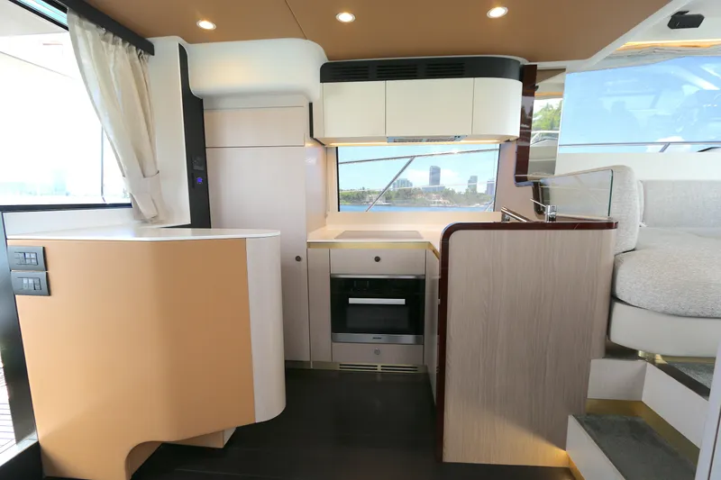 Slide: The Image of Luxurious interior of a 2020 Azimut 55 yacht featuring a modern kitchen and seating area. - 2