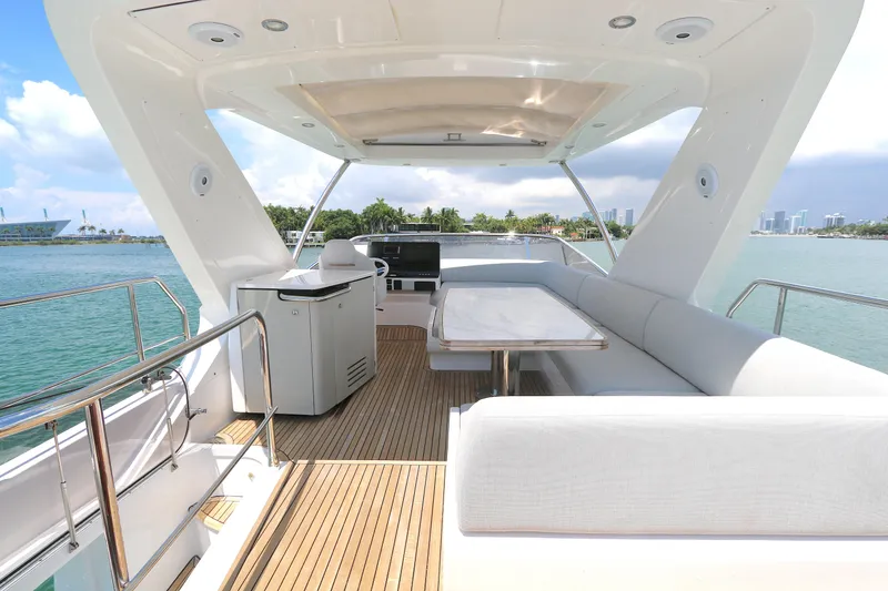 Slide: The Image of Luxurious 2020 Azimut 55 yacht deck with seating, table, and ocean view. - 24