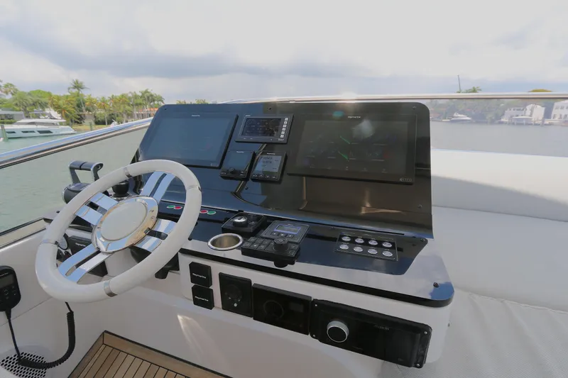 Slide: The Image of Cockpit of 2020 Azimut 55 yacht with modern navigation controls and steering wheel. - 26