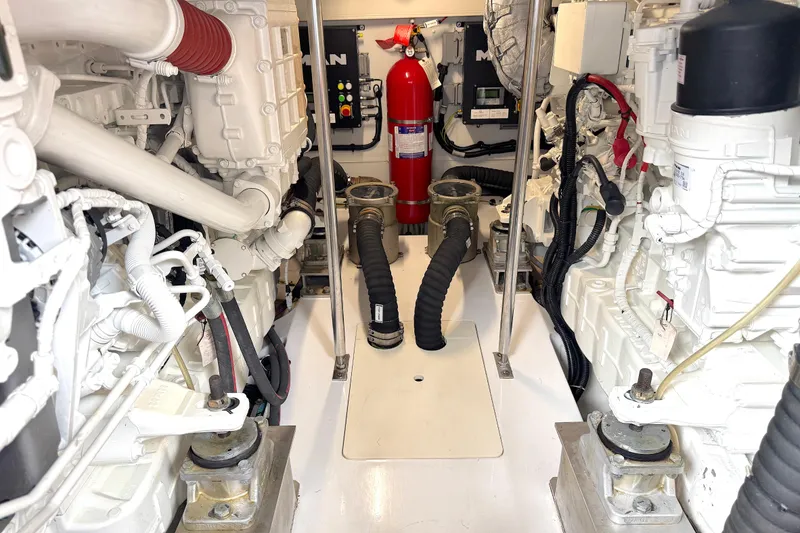 Slide: The Image of Engine room of a 2020 Azimut 55 yacht, featuring mechanical components and fire extinguisher. - 28