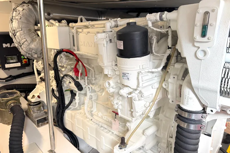 Slide: The Image of Engine room of a 2020 Azimut 55 yacht, featuring a MAN engine. - 29
