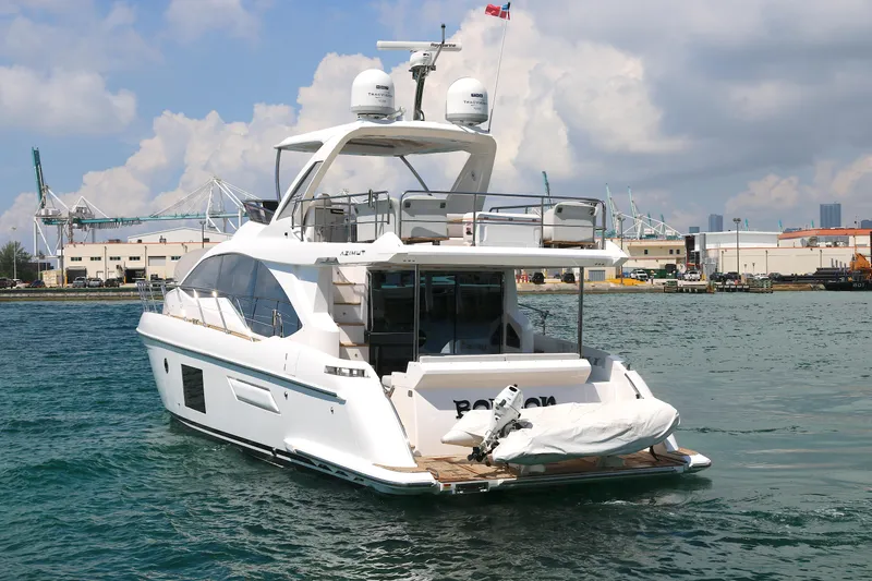 Slide: The Image of 2020 Azimut 55 yacht docked in a marina with industrial background. - 32