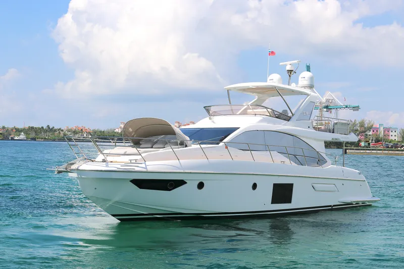 Slide: The Image of Luxury 2020 Azimut 55 yacht cruising on clear blue waters under a sunny sky. - 33