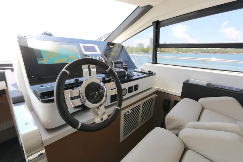 Slide: The Image of Luxurious Azimut 55 yacht helm with modern controls and scenic ocean view, 2020 model. - 7