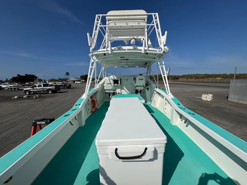 Slide: The Image of Custom 2018 Ocean Master boat with teal deck, docked under clear blue sky. - 15