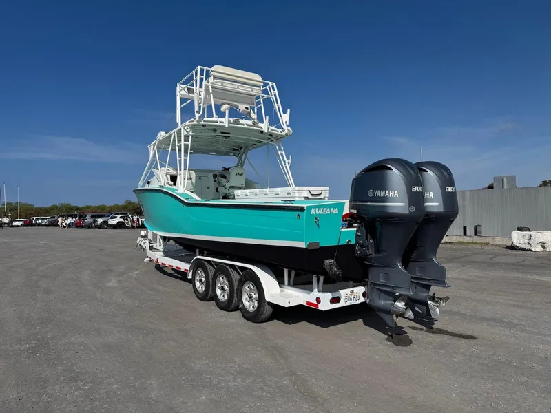 Slide: The Image of Custom Ocean Master 2018 boat with dual Yamaha engines on a trailer. - 9