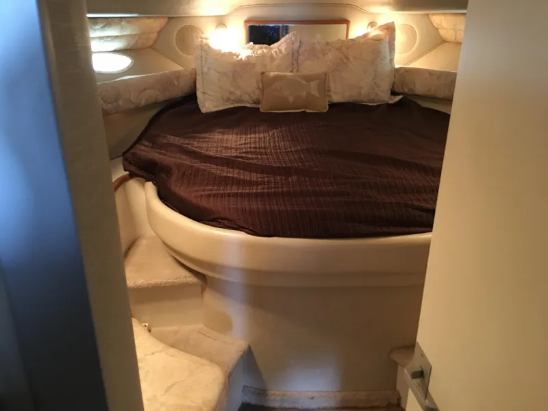 Slide: The Image of 1996 Sea Ray 400 Express Cruiser cabin with cozy bed and ambient lighting. - 10