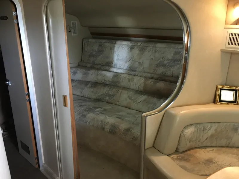 Slide: The Image of 1996 Sea Ray 400 Express Cruiser interior with curved seating and elegant design. - 14