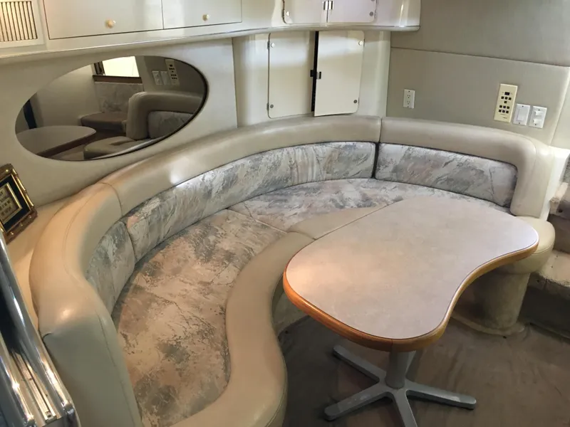 Slide: The Image of 1996 Sea Ray 400 Express Cruiser interior with curved seating and table. - 23