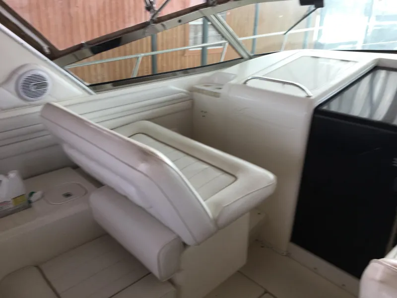 Slide: The Image of 1996 Sea Ray 400 Express Cruiser interior with white seating and dashboard. - 24