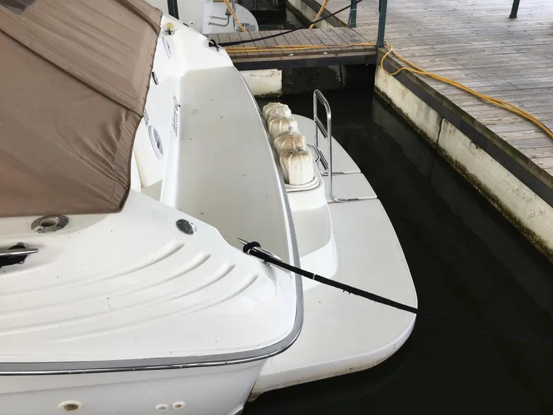 Slide: The Image of 1996 Sea Ray 400 Express Cruiser docked, showing rear deck and mooring line. - 29
