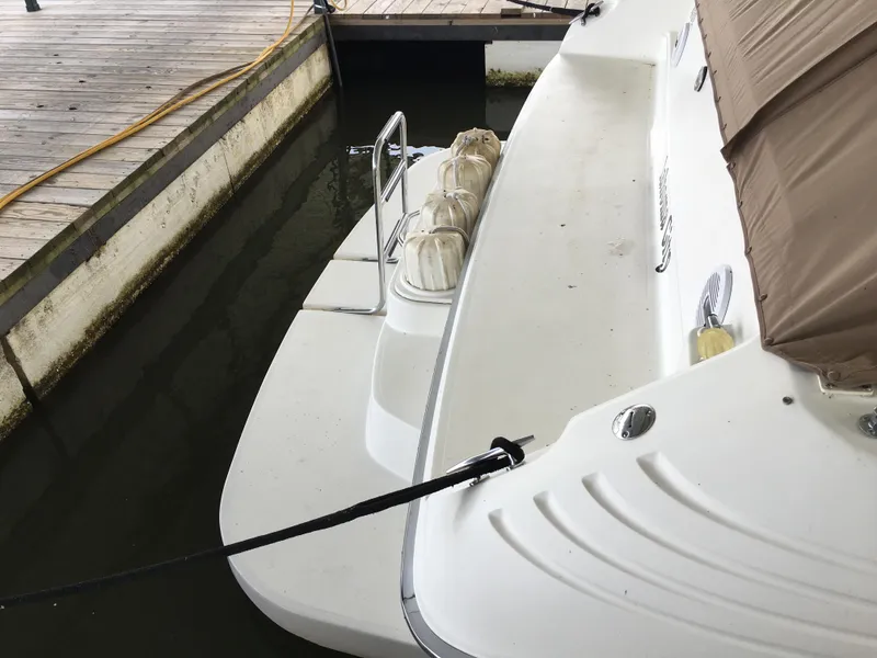 Slide: The Image of 1996 Sea Ray 400 Express Cruiser docked, showing swim platform and ladder. - 30