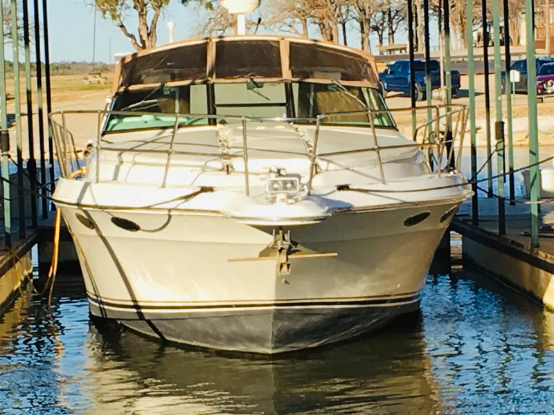 Slide: The Image of 1996 Sea Ray 400 Express Cruiser docked in marina, front view. - 31