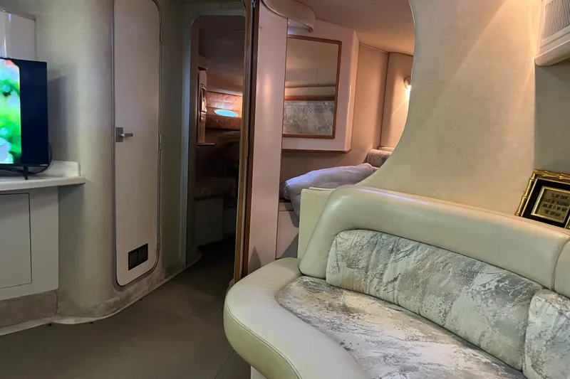 Slide: The Image of Interior of a 1996 Sea Ray 400 Express Cruiser with cozy seating and modern decor. - 37