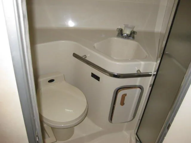Slide: The Image of Bathroom interior of 1996 Sea Ray 400 Express Cruiser with toilet and sink. - 4