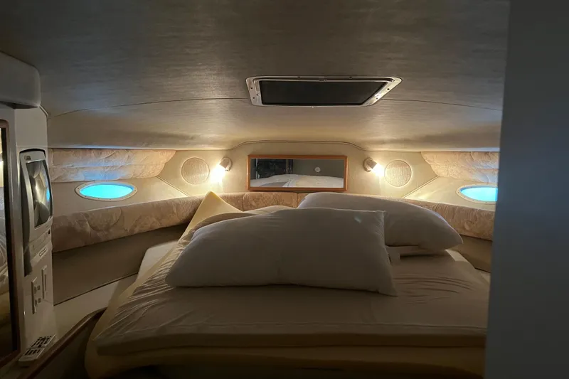 Slide: The Image of Interior cabin of 1996 Sea Ray 400 Express Cruiser with cozy bedding and ambient lighting. - 40