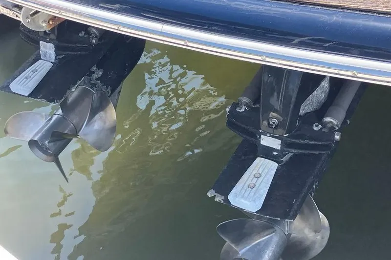 Slide: The Image of 2010 Chris-Craft Corsair 28 boat propellers submerged in water. - 12