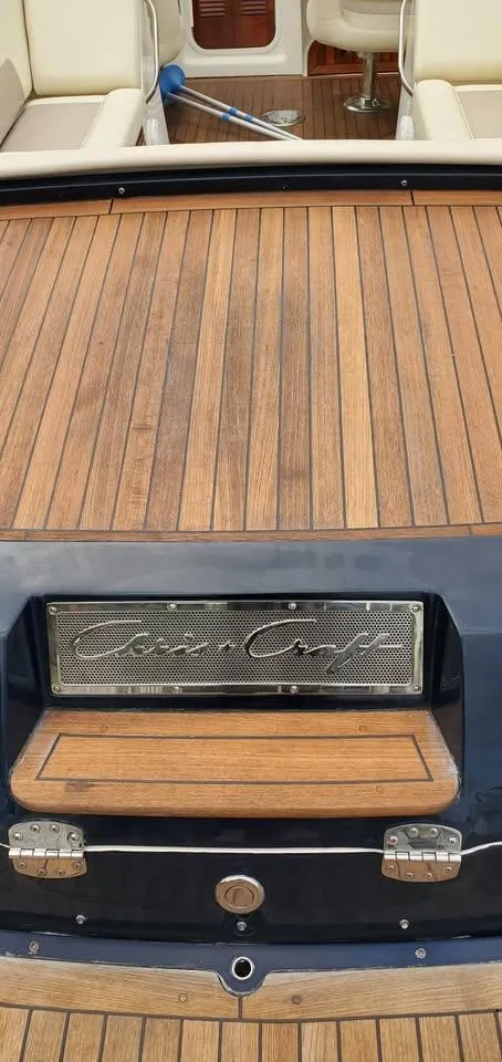Slide: The Image of 2010 Chris-Craft Corsair 28 boat with teak deck and branded emblem. - 4