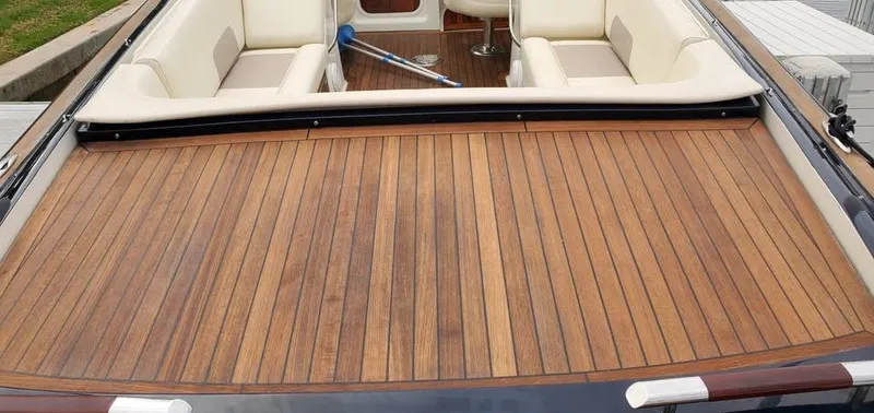 Slide: The Image of 2010 Chris-Craft Corsair 28 boat with teak deck and cream seating. - 8