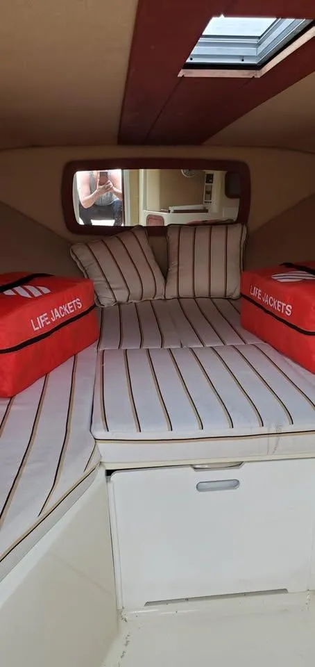 Slide: The Image of Interior cabin of 2010 Chris-Craft Corsair 28 with striped cushions and life jackets. - 9
