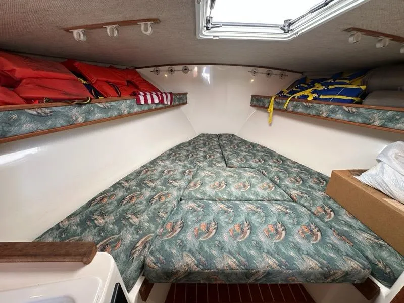 Slide: The Image of 2005 Carolina Classic 28 cabin interior with patterned cushions and life jackets. - 12