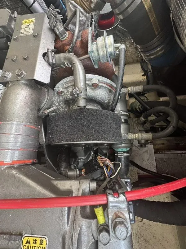 Slide: The Image of Engine components of a 2005 Carolina Classic 28 boat, featuring hoses and wiring. - 19