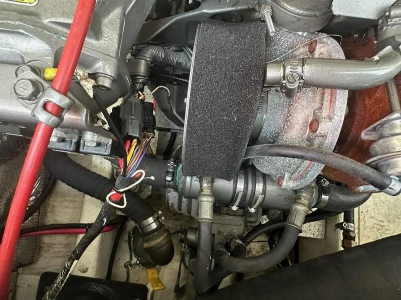 Slide: The Image of Engine components of a 2005 Carolina Classic 28 boat, featuring hoses and wiring. - 21