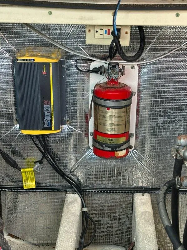 Slide: The Image of Engine compartment of a 2005 Carolina Classic 28 with fire extinguisher and electrical components. - 22