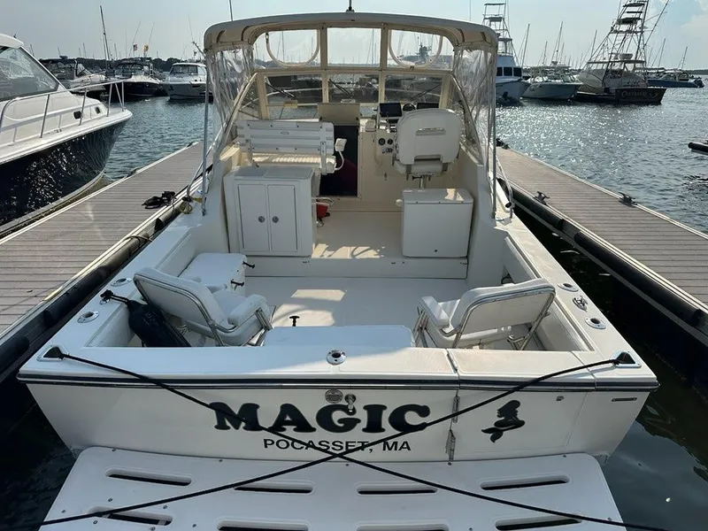 Slide: The Image of 2005 Carolina Classic 28 boat named "Magic" docked at Pocasset, MA marina. - 3