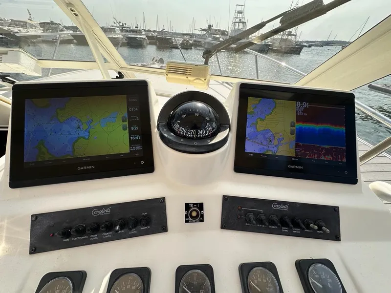 Slide: The Image of Control panel of a 2005 Carolina Classic 28 boat with Garmin navigation displays. - 7