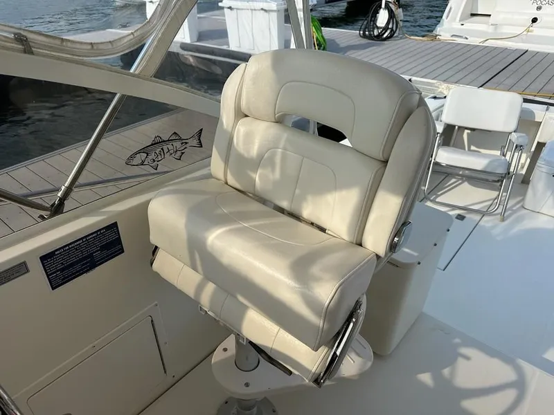 Slide: The Image of Captain's chair on a 2005 Carolina Classic 28 boat, docked by the water. - 9