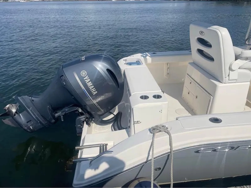 Slide: The Image of 2021 Cobia 220 Center Console boat with Yamaha outboard motor on calm water. - 4