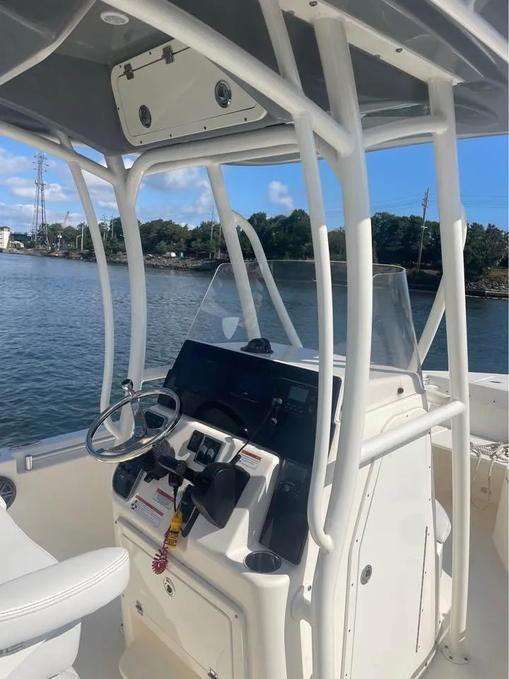 Slide: The Image of 2021 Cobia 220 Center Console boat interior with steering wheel and controls. - 6