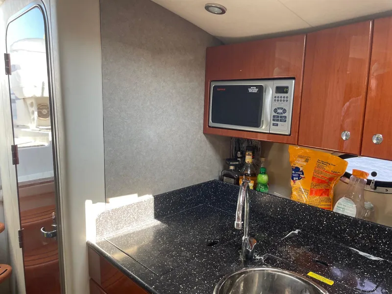 Slide: The Image of 2008 Formula 31 PC yacht kitchen with microwave, sink, and storage cabinets. - 15