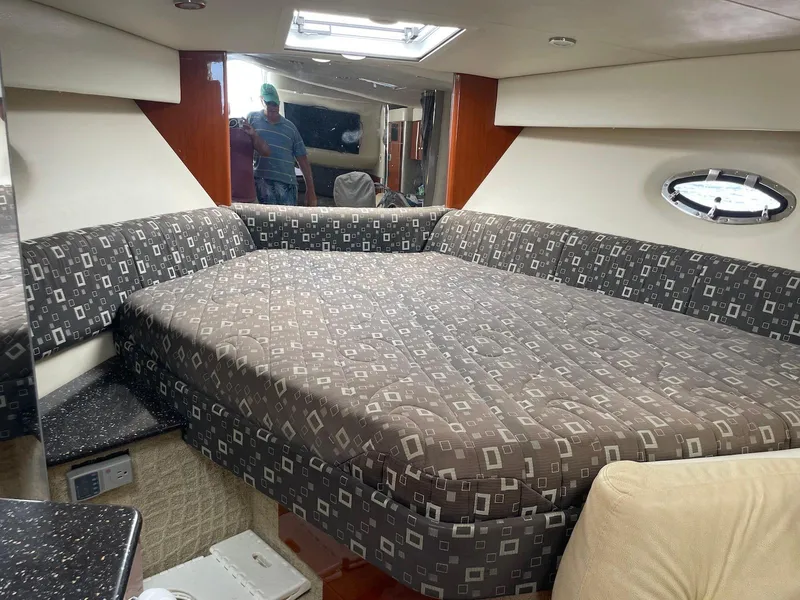 Slide: The Image of 2008 Formula 31 PC cabin interior with patterned bedding and porthole window. - 16