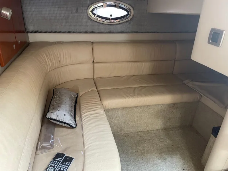 Slide: The Image of 2008 Formula 31 PC cabin interior with beige seating and a small window. - 17