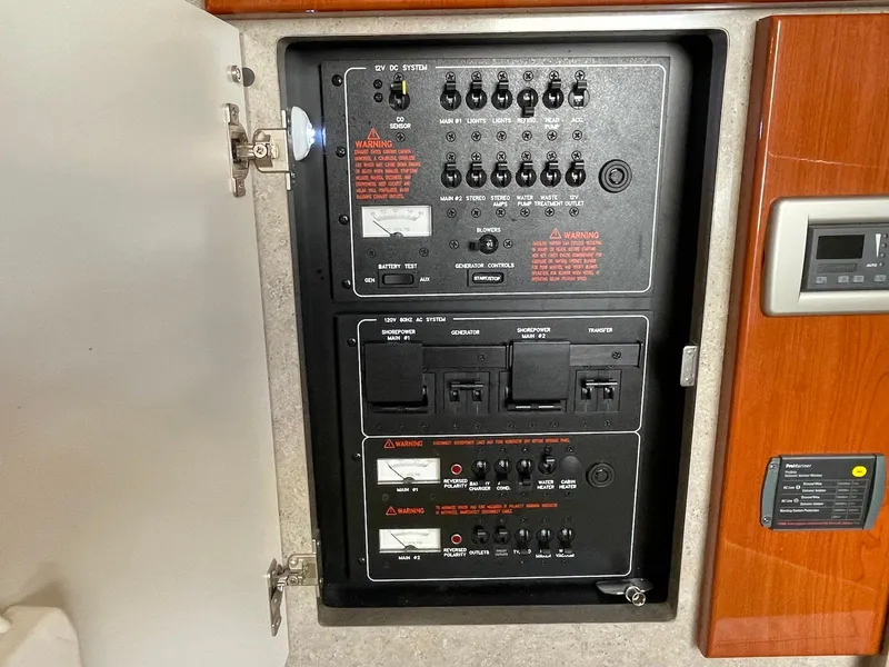 Slide: The Image of Electrical control panel inside a 2008 Formula 31 PC boat, featuring various switches and warnings. - 18