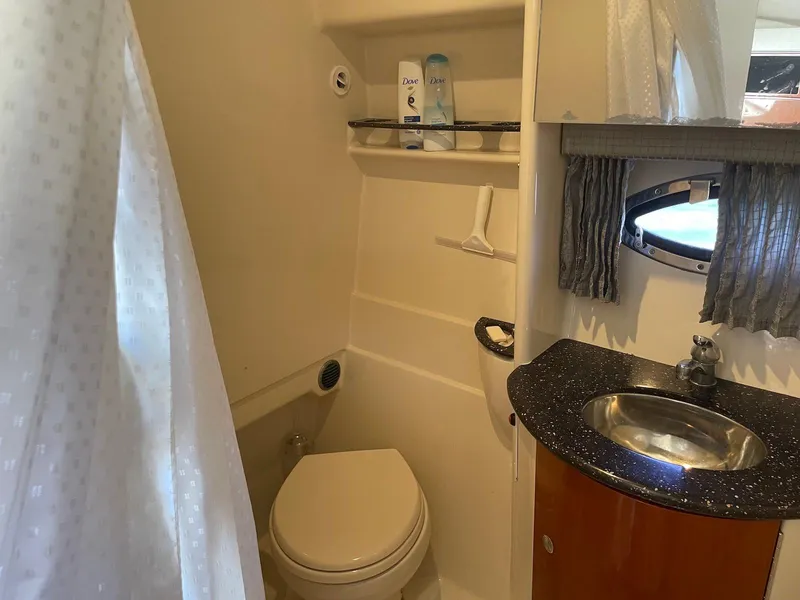 Slide: The Image of 2008 Formula 31 PC bathroom with toilet, sink, and shower curtain. - 19