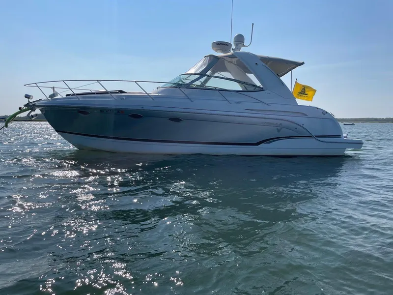 Slide: The Image of 2008 Formula 31 PC boat on calm water under clear sky. - 2
