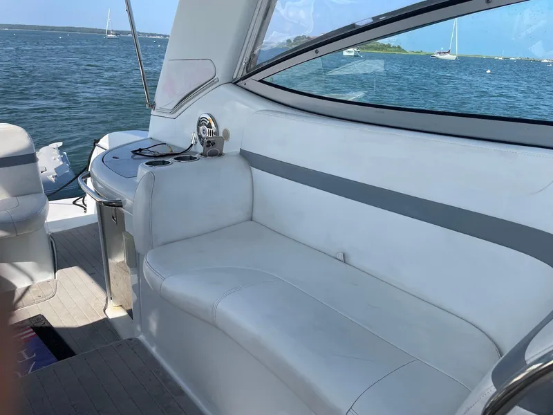 Slide: The Image of 2008 Formula 31 PC boat interior with white seating, ocean view, and sailboats in the background. - 5