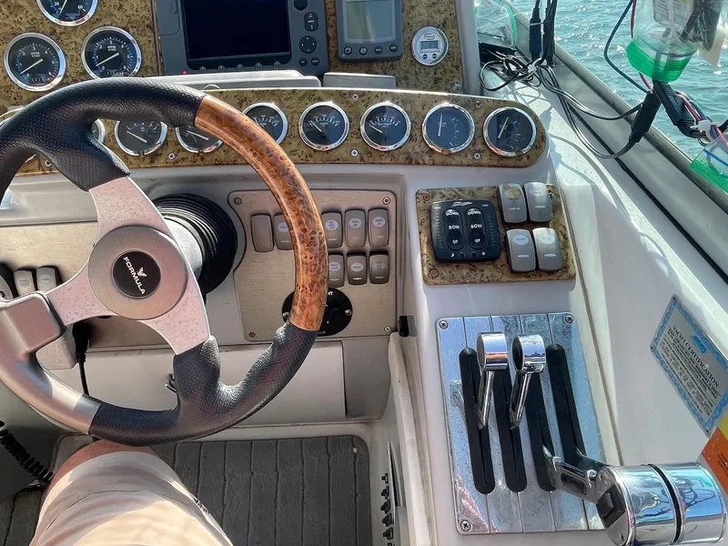 Slide: The Image of 2008 Formula 31 PC boat dashboard with steering wheel and control panel. - 7