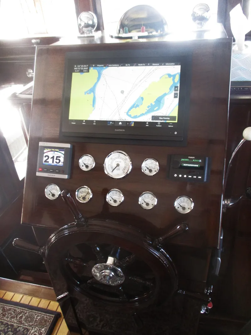Slide: The Image of Vintage 1929 Gidley 52 yacht helm with modern navigation display and classic gauges. - 12