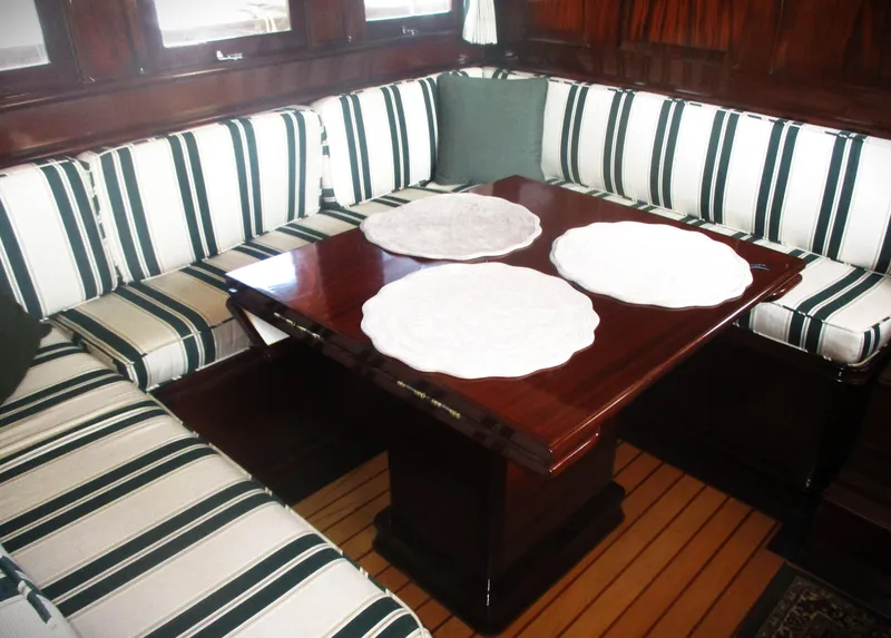 Slide: The Image of Vintage 1929 Gidley 52 yacht interior with striped seating and wooden table. - 15