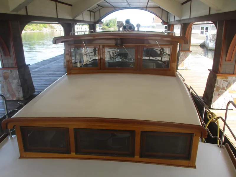 Slide: The Image of Vintage 1929 Gidley 52 Retro Modern Motor Yacht docked under a covered pier. - 20